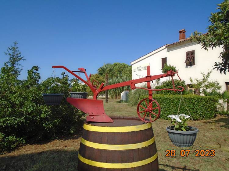 A red metal object on a barrel

Description automatically generated